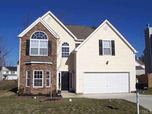 164 Trevor Ridge Drive Holly Springs, NC 27540 - Photo 1 of 12 a front view of a house with a yard