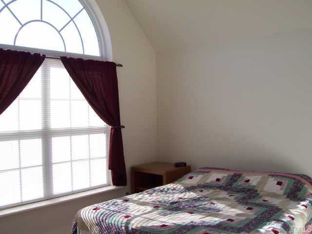 164 Trevor Ridge Drive Holly Springs, NC 27540 - Photo 11 of 12 a bedroom with a bed and a window