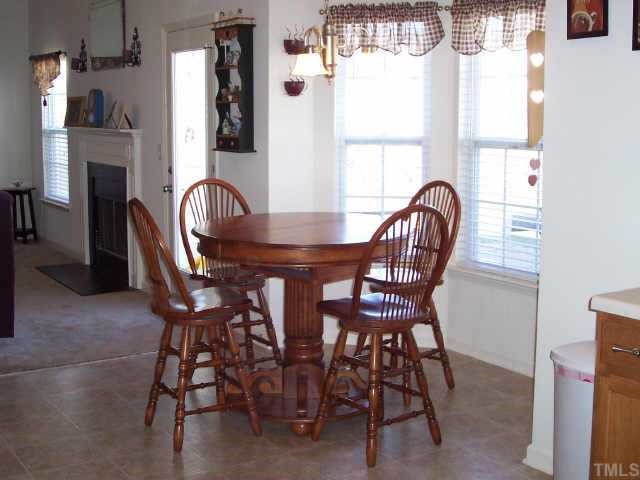 164 Trevor Ridge Drive Holly Springs, NC 27540 - Photo 6 of 12 a view of a dining room with furniture and a window