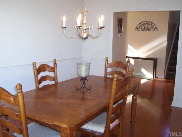 164 Trevor Ridge Drive Holly Springs, NC 27540 - Photo 8 of 12 a view of a dining room with furniture and chandelier