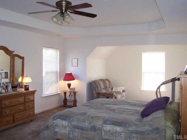 164 Trevor Ridge Drive Holly Springs, NC 27540 - Photo 10 of 12 a bed room with a bed and a window