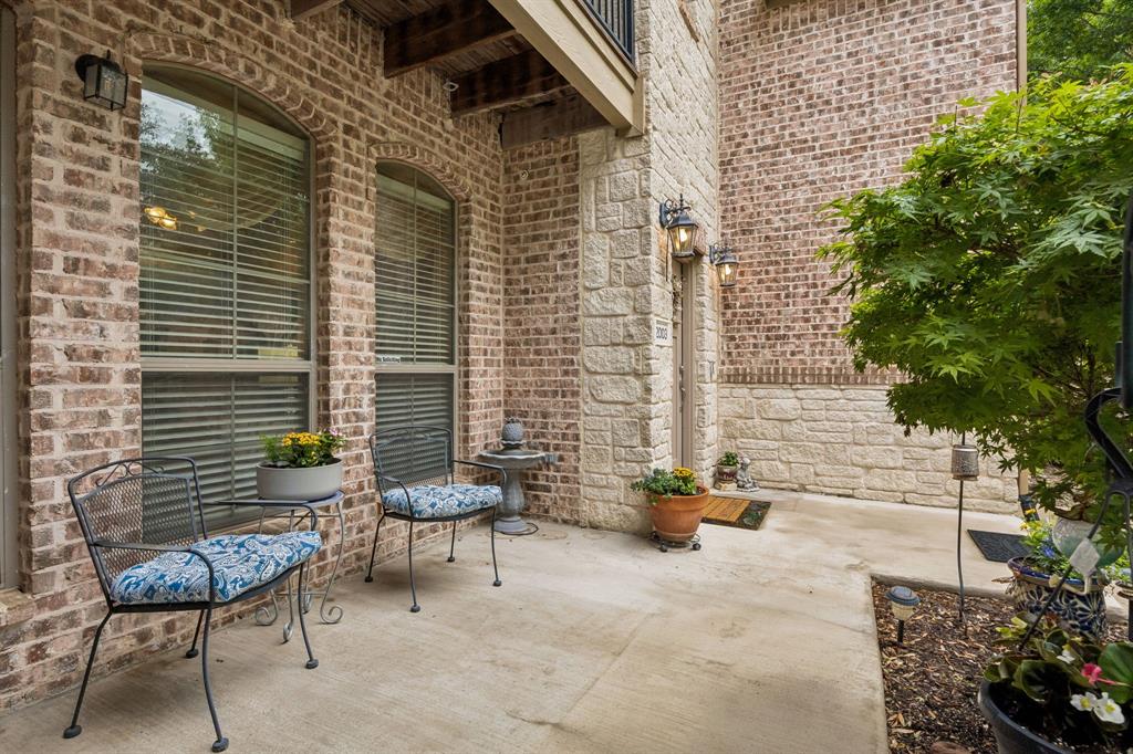 2003 Downing Street Allen, TX 75013 - Photo 32 of 40 The spacious front patio creates a serene outdoor setting with room for seating and decorative planters.