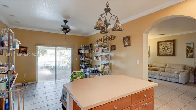 a room with furniture a chandelier a rug and a window