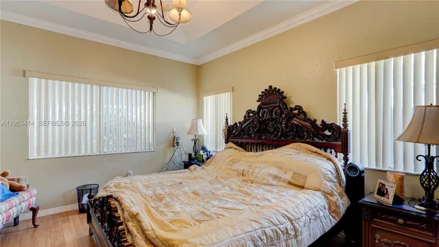 a bed room with a bed and a chandelier