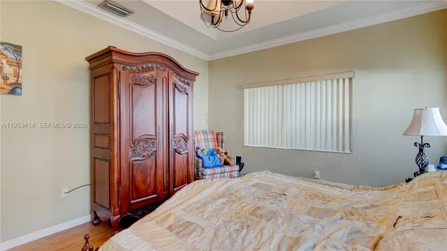 a bedroom with a bed and a chandelier