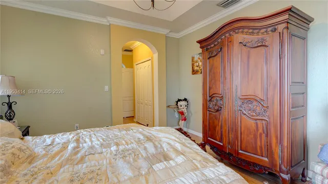 a bedroom with a bed and a mirror