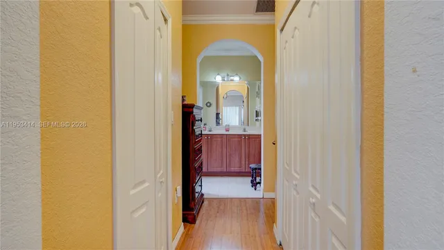 a view of a hallway with wooden floor