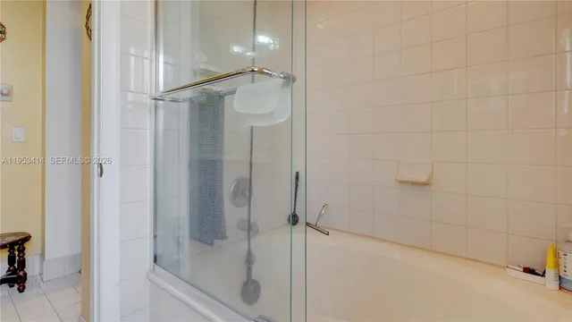 a bathroom with a glass shower door