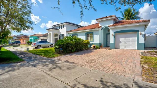 a front view of a house with a yard and outdoor seating