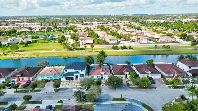 an aerial view of residential houses with outdoor space and swimming pool
