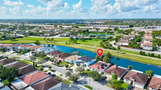 an aerial view of a house with a yard
