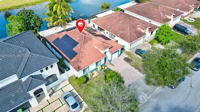 an aerial view of a house with a yard