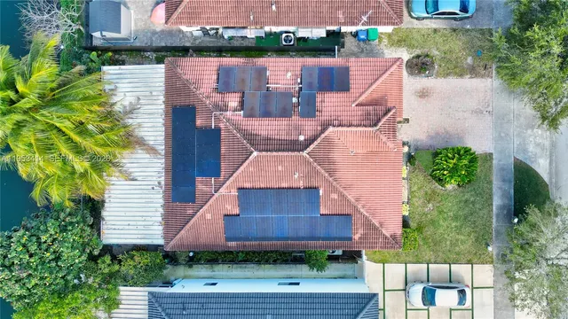 an aerial view of a house with a yard and outdoor seating