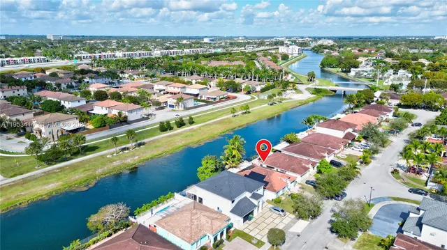 an aerial view of a city with lots of residential buildings and mountain view in back