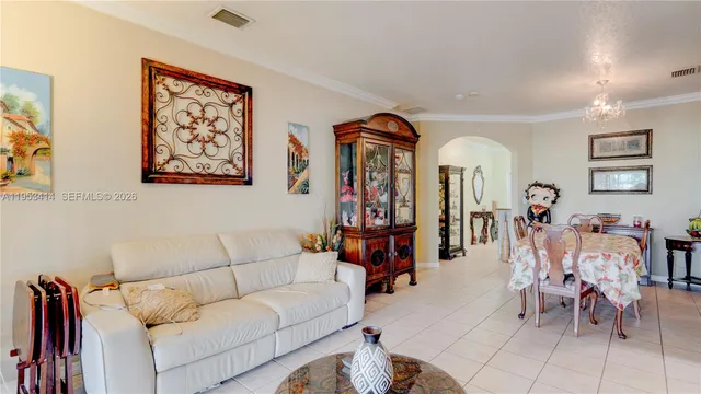 a living room with furniture and a dining table
