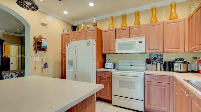 a kitchen with stainless steel appliances a refrigerator sink and cabinets