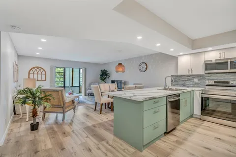 a kitchen with a sink stove and cabinets