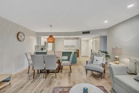 a living room with furniture a fireplace and a table