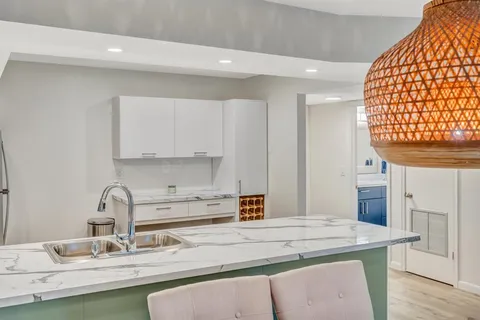 a kitchen with a sink cabinets and window