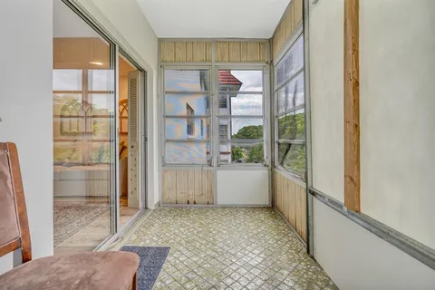 a view of an entryway with wooden floor and a window