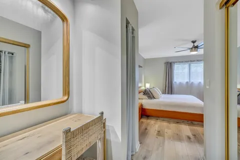 a bedroom with a bed and a mirror