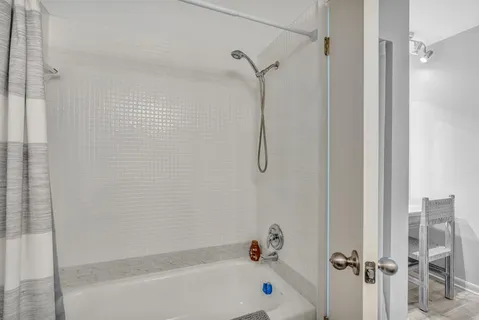 a bathroom with a shower and a bathtub