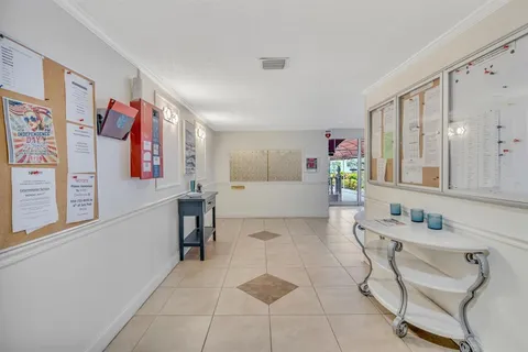 a living room with furniture and a kitchen area