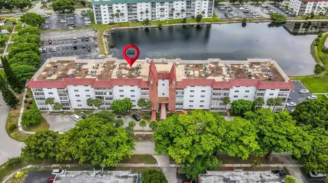 an aerial view of residential building with outdoor space lake view and lake view