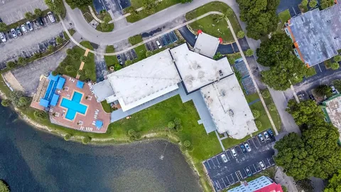an aerial view of a house with a swimming pool