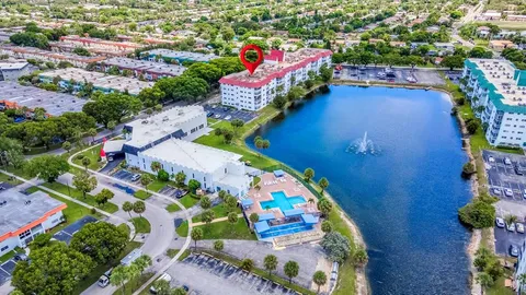 an aerial view of a house with a yard and garden