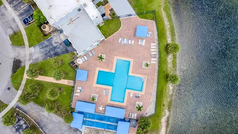an aerial view of a house with a swimming pool yard and mountain view in back