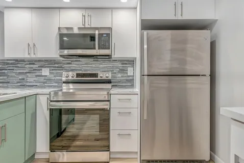 a kitchen with appliances a refrigerator and a microwave