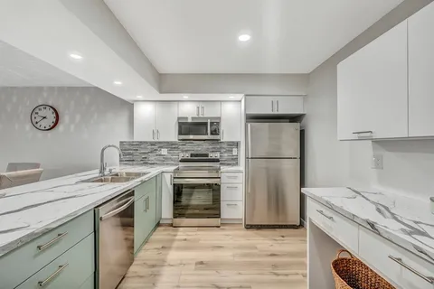 a kitchen with a sink stove and refrigerator
