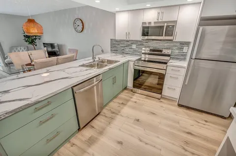 a kitchen with a sink stove and refrigerator