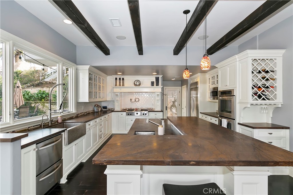 3124 Pachappa Drive Riverside, CA 92506 - Photo 20 of 50 a kitchen with stainless steel appliances granite countertop a sink stove and wooden cabinets