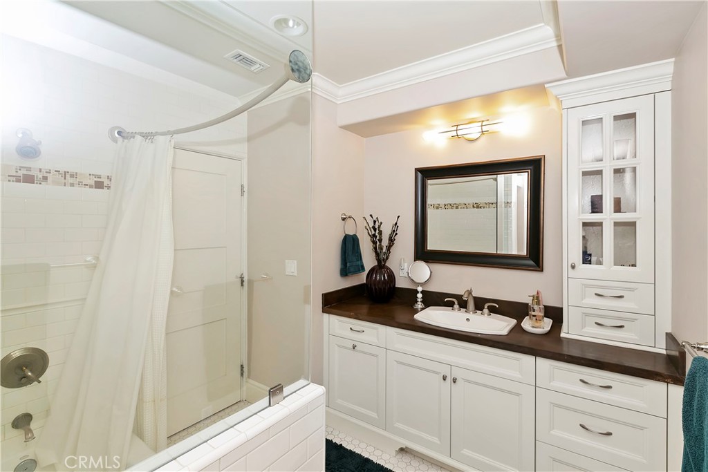 3124 Pachappa Drive Riverside, CA 92506 - Photo 29 of 50 a bathroom with a double vanity sink and mirror with shower