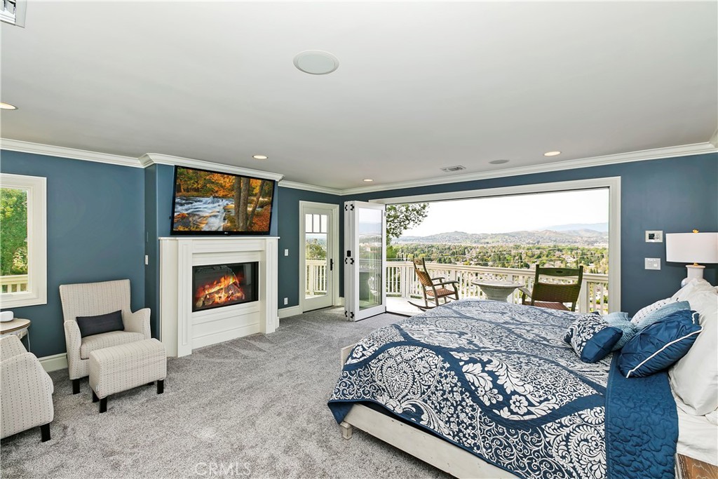 3124 Pachappa Drive Riverside, CA 92506 - Photo 31 of 50 a bedroom with a large bed and a fireplace