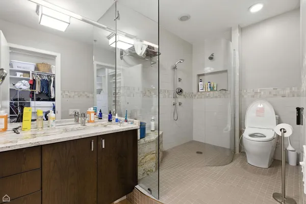 a bathroom with a sink toilet and shower