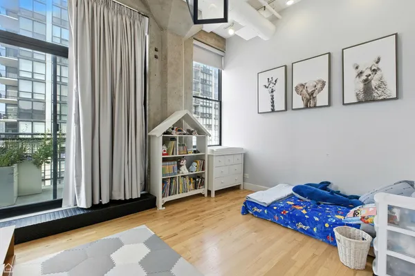 a bedroom with furniture and a book shelf