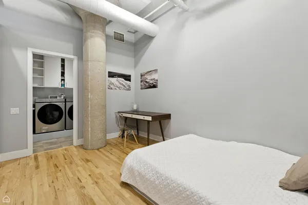 a bedroom with a bed and a table in it