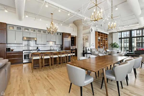 a large kitchen with a table and chairs