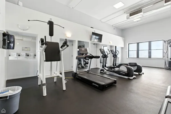 a room with gym equipment and a large window