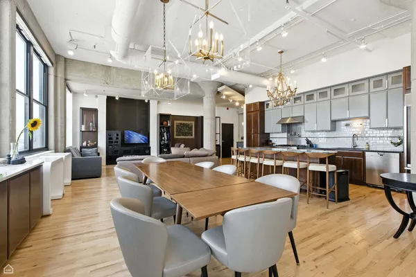 a large kitchen with a table and chairs