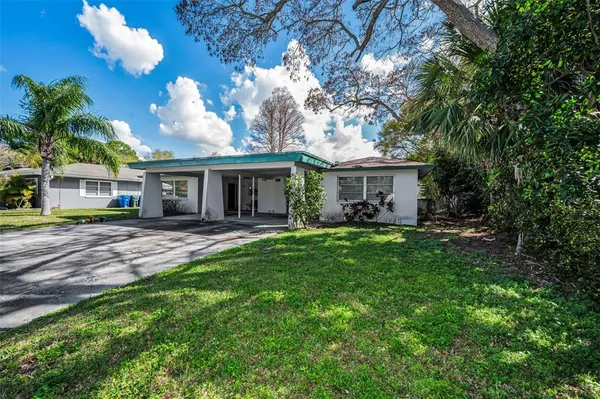 a view of house that has a yard