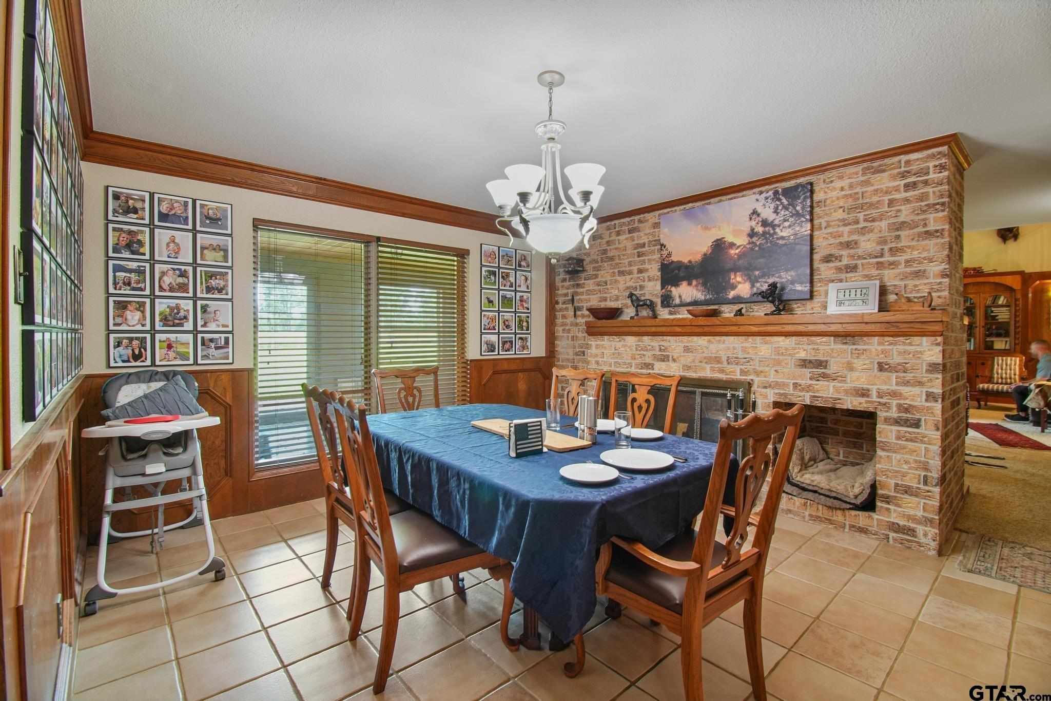 11074 State Highway 64 Overton, TX 75684 - Photo 8 of 42 a view of a dining room with furniture a chandelier and large windows