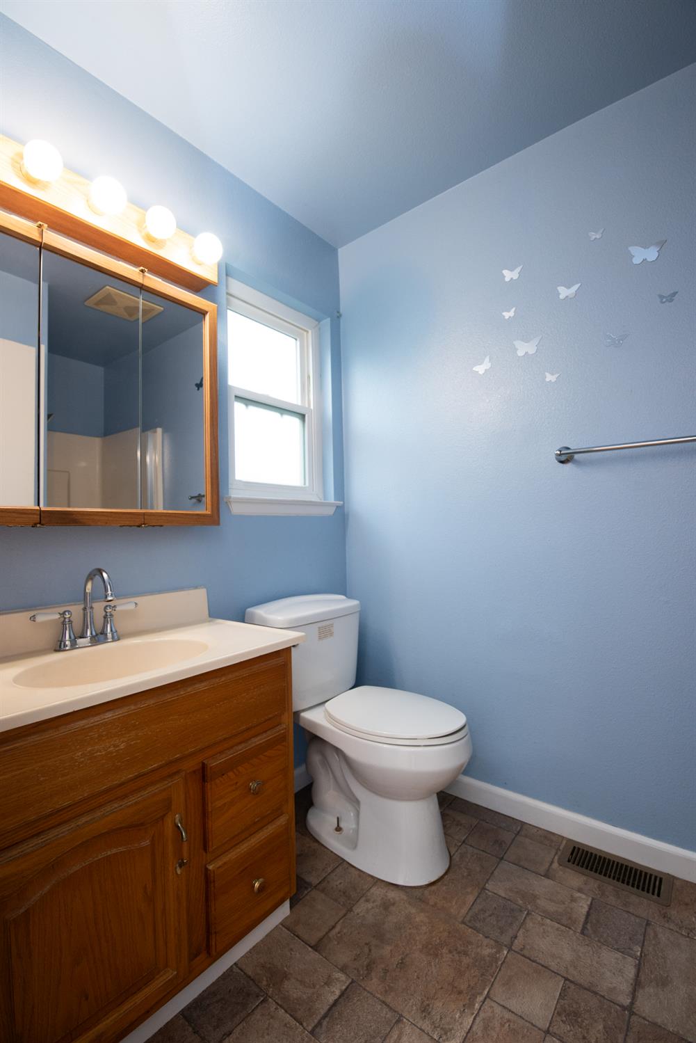 404 Trask Lane Modesto, CA 95354 - Photo 13 of 25 a bathroom with a toilet sink and mirror