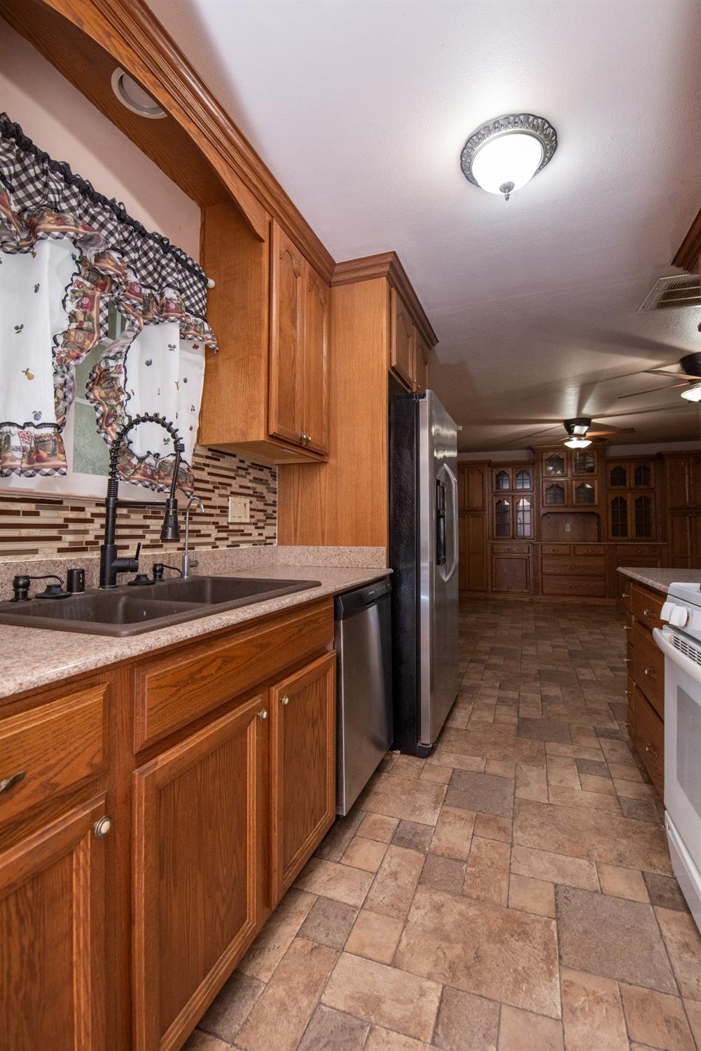 404 Trask Lane Modesto, CA 95354 - Photo 16 of 25 a kitchen with stainless steel appliances granite countertop a sink and cabinets