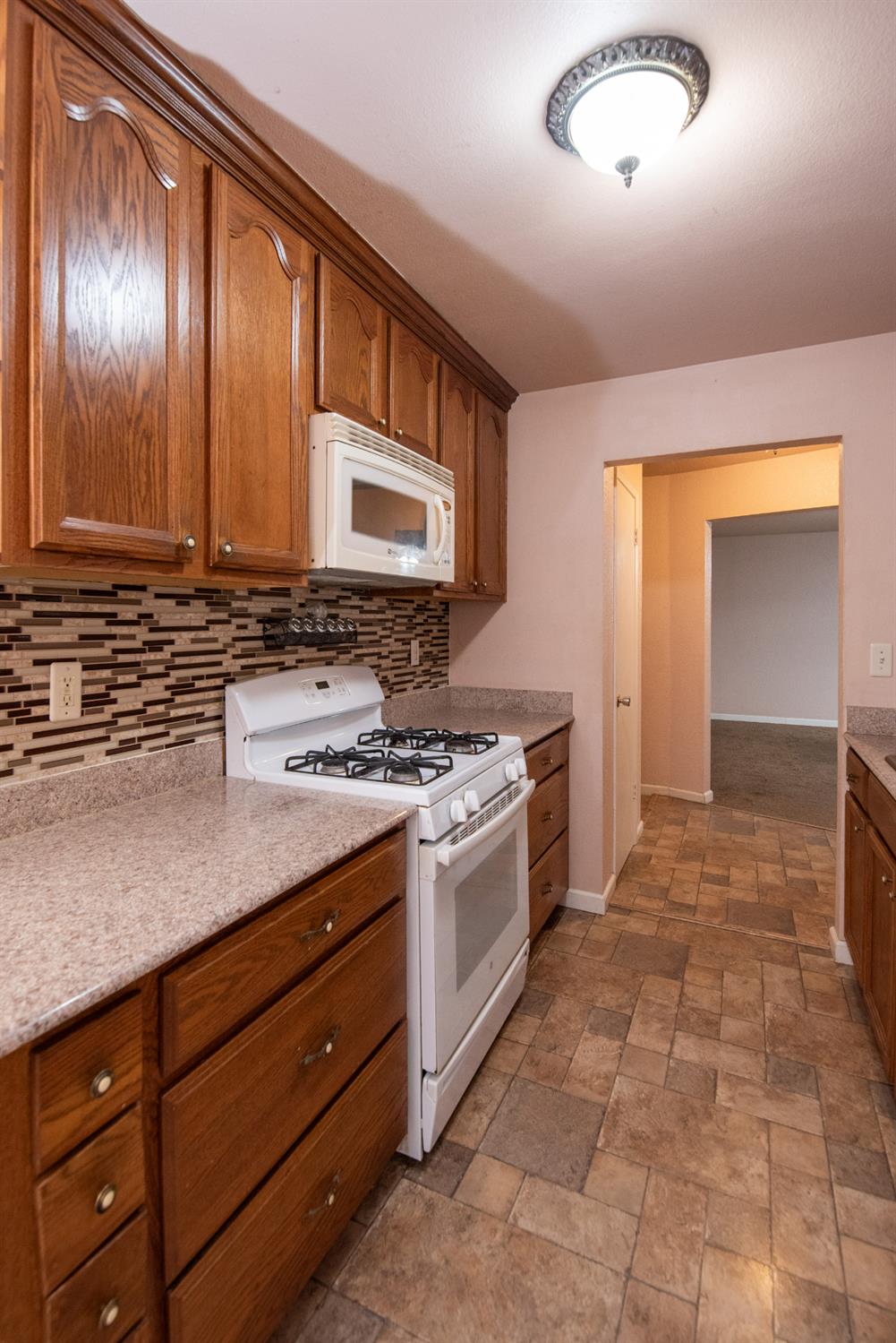 404 Trask Lane Modesto, CA 95354 - Photo 18 of 25 a kitchen with a stove window and cabinets