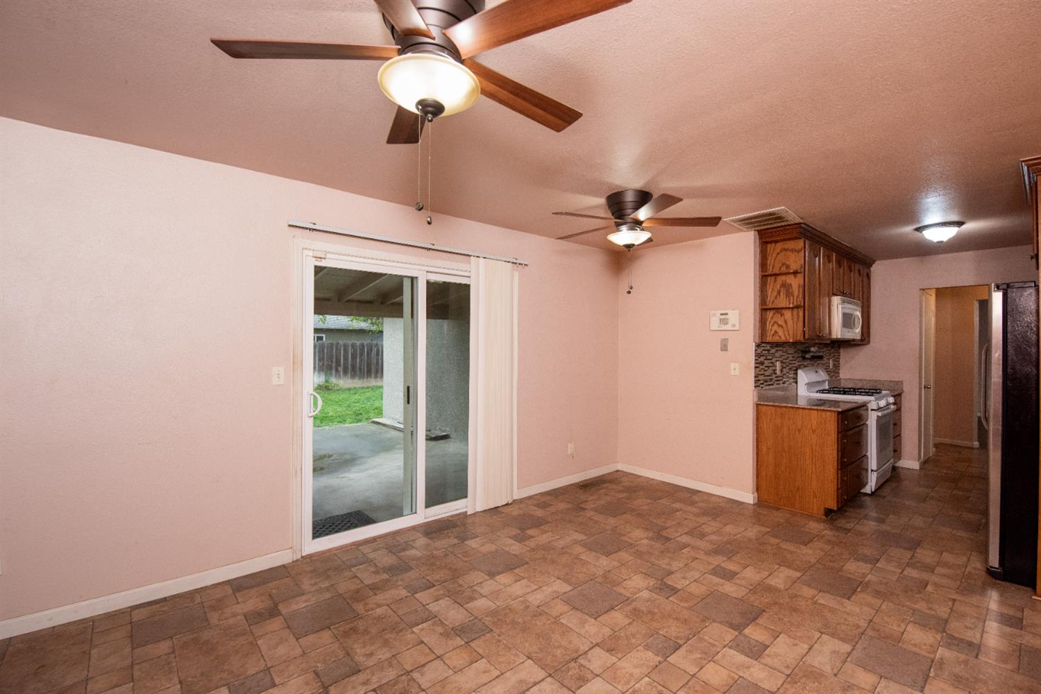 404 Trask Lane Modesto, CA 95354 - Photo 20 of 25 a view of a kitchen with a sink and a refrigerator