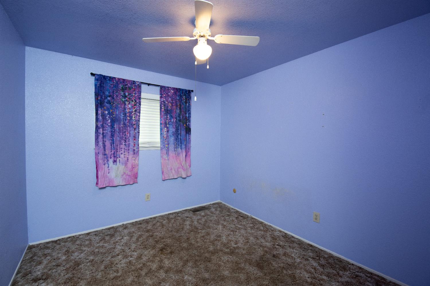 404 Trask Lane Modesto, CA 95354 - Photo 6 of 25 an empty room with windows and fan